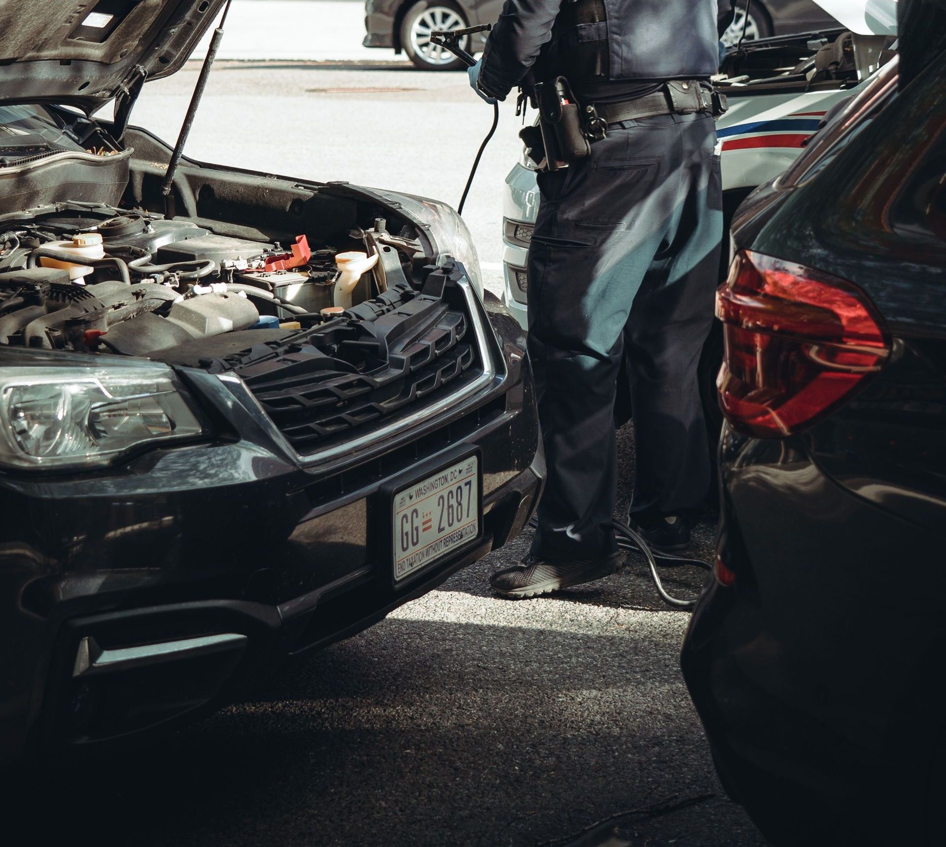 A police officer assists a car with a breakdown on the streets of Washington DC.