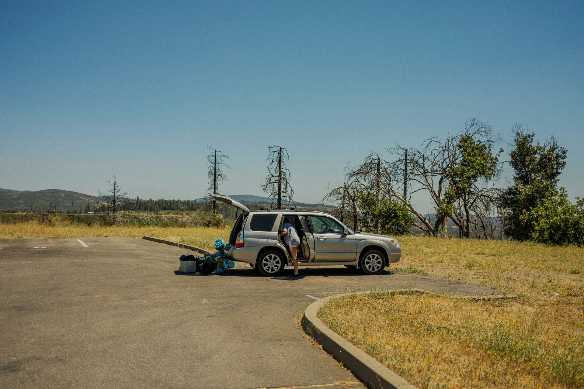 a person standing next to a car